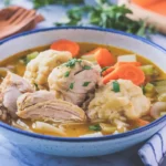 Delicious homemade chicken and dumplings with fluffy dumplings and savory broth.