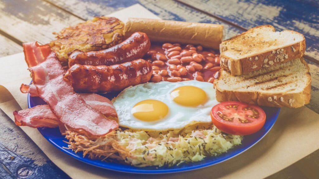 Ingredients for a traditional Irish breakfast including black pudding and tomatoes.