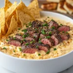 Top View Of Smoked Steak Queso Dip Served In A Bowl, Garnished With Cilantro, Accompanied By Tortilla Chips, Creamy Sauce, Fresh Salsa, And Chopped Cilantro..