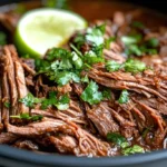 Cooker Barbacoa Beef Topped With Fresh Cilantro And Lime In A Rich Sauce